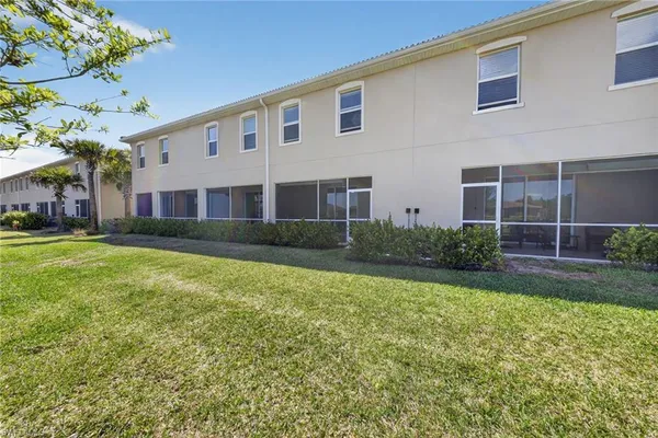 an aerial view of a house with a garden and lake view