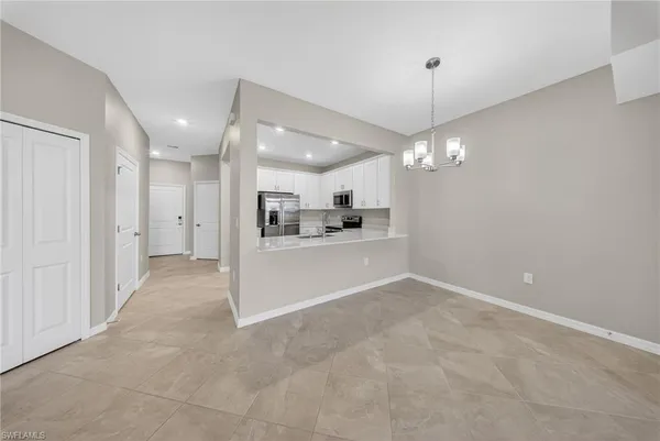 a view of a kitchen with a sink and a refrigerator