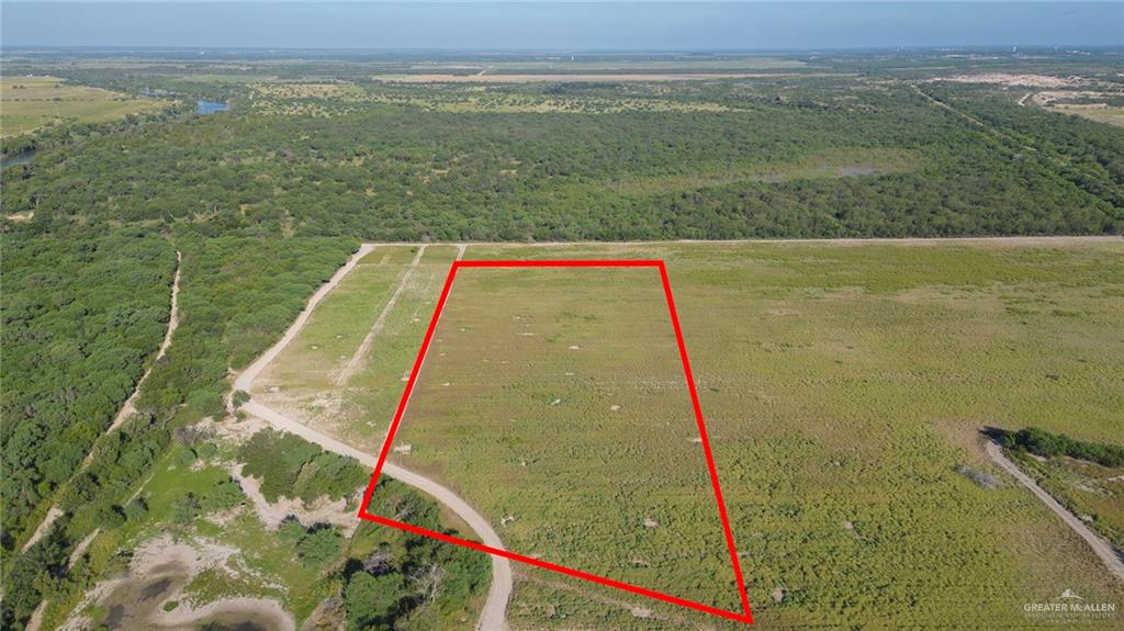 0 Eustacio Flores Road Sullivan City, TX 78595 - Photo 2 of 5 Front aerial view of the lot with clear road access and open terrain ready for development.