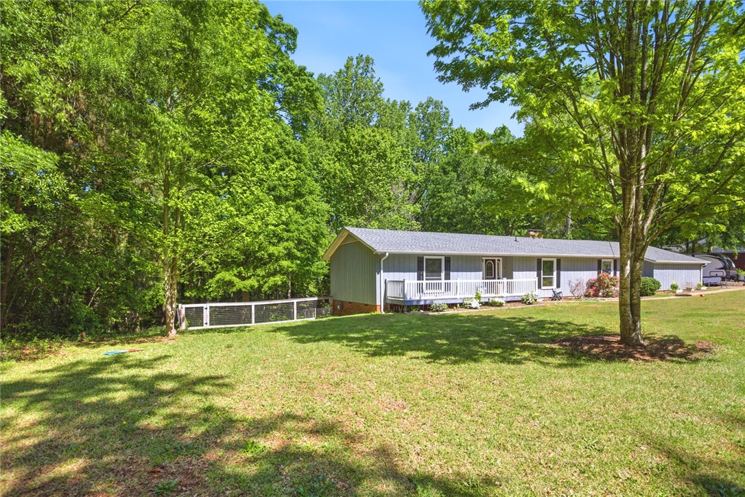 311 Cumberland Way Anderson, SC 29621 - Photo 35 of 44 A quaint ranch home nestled amongst verdant trees with a welcoming front porch.