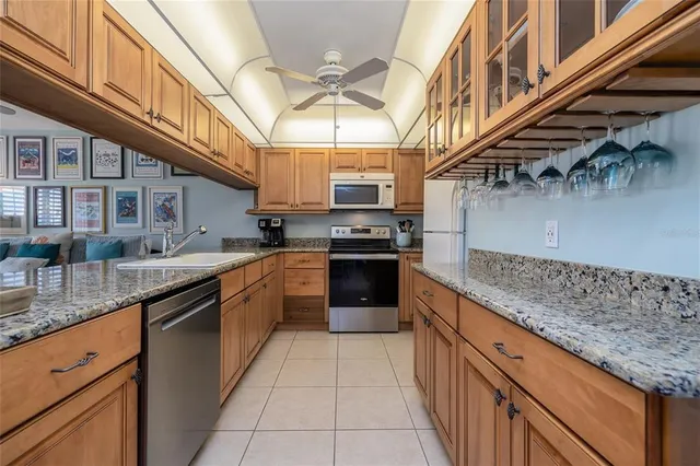 a kitchen with stainless steel appliances granite countertop a sink and cabinets