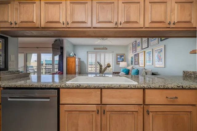 a kitchen with granite countertop a sink and cabinets