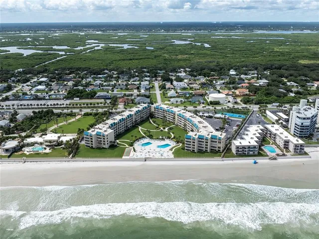 an aerial view of residential houses with outdoor space and street view
