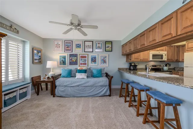 a living room with furniture a dining table and kitchen view