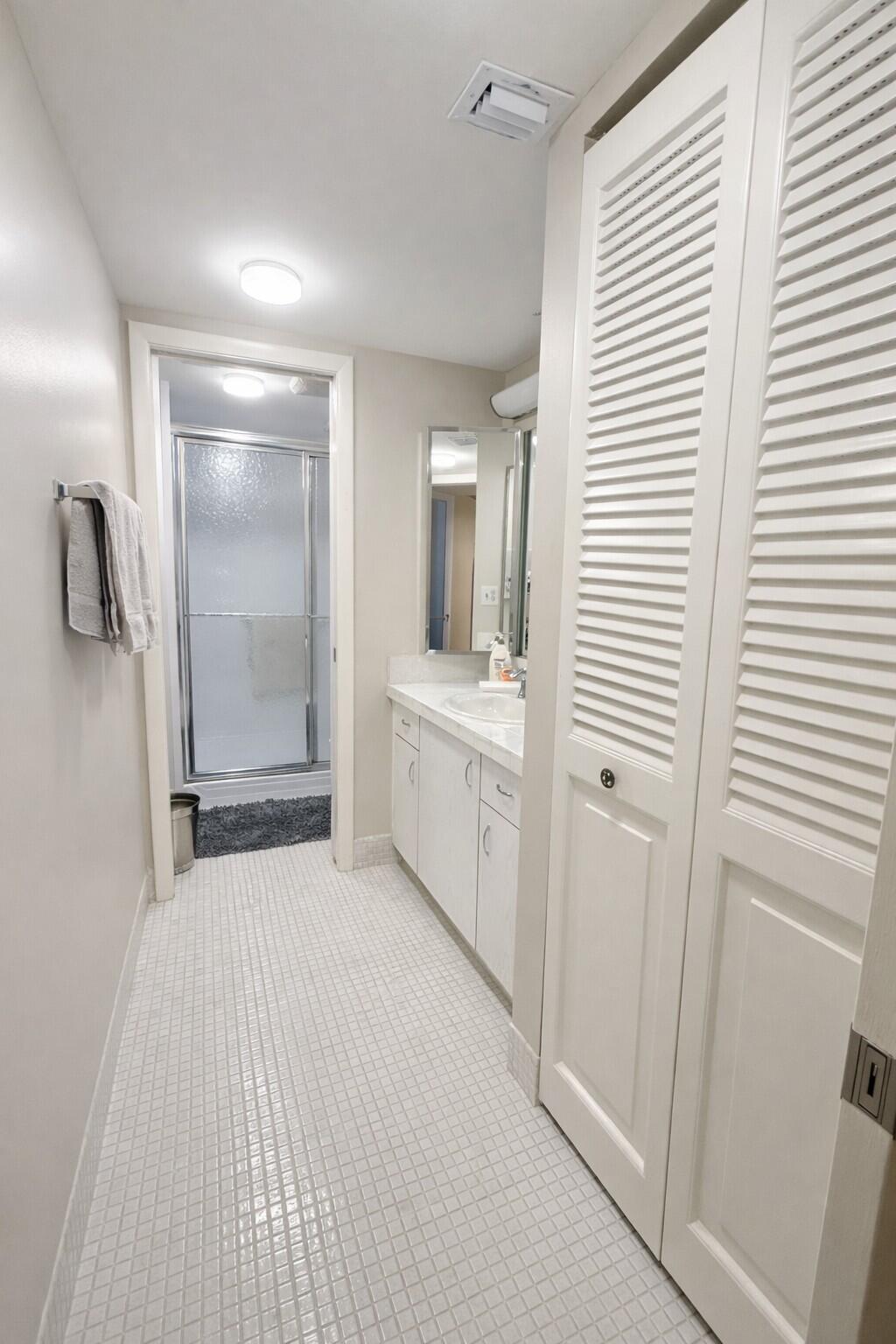 3030 Wolverton East Boca Raton, FL 33434 - Photo 7 of 13 a bathroom with a sink and a mirror