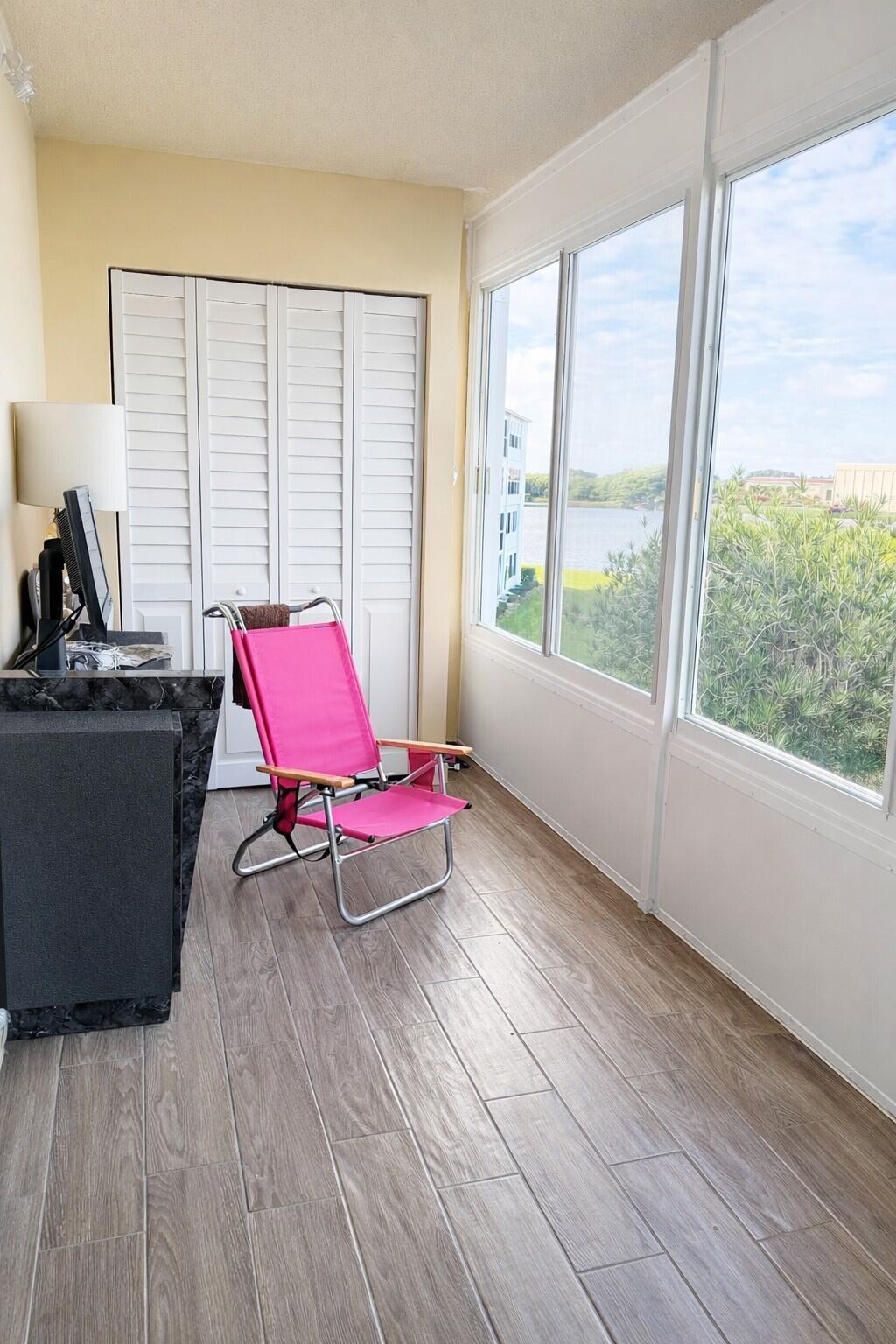 3030 Wolverton East Boca Raton, FL 33434 - Photo 10 of 13 a room with wooden floor and windows