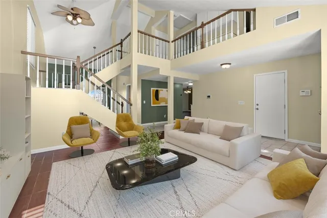 a living room with furniture and stairs