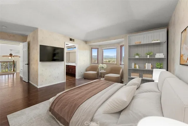 a bedroom with a large bed and a television