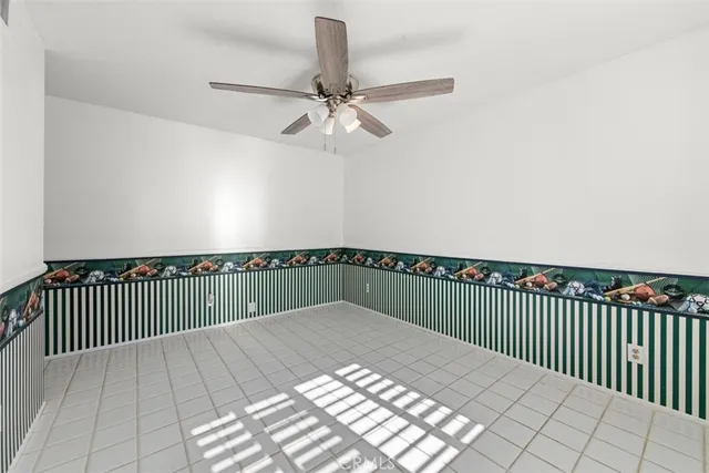 an empty room with wooden floor closet and windows