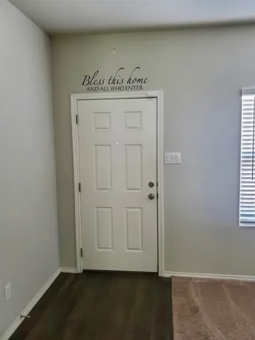 an entryway with wooden floor