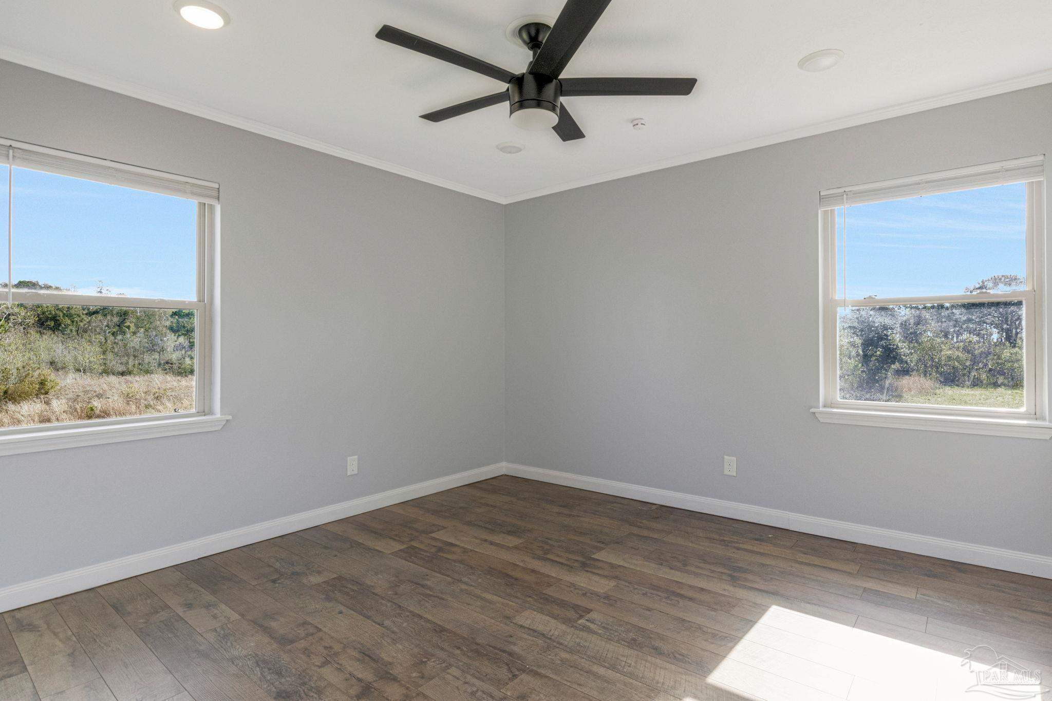 302 Garcon Point Road Milton, FL 32583 - Photo 21 of 51 a view of a livingroom with a window and a ceiling fan