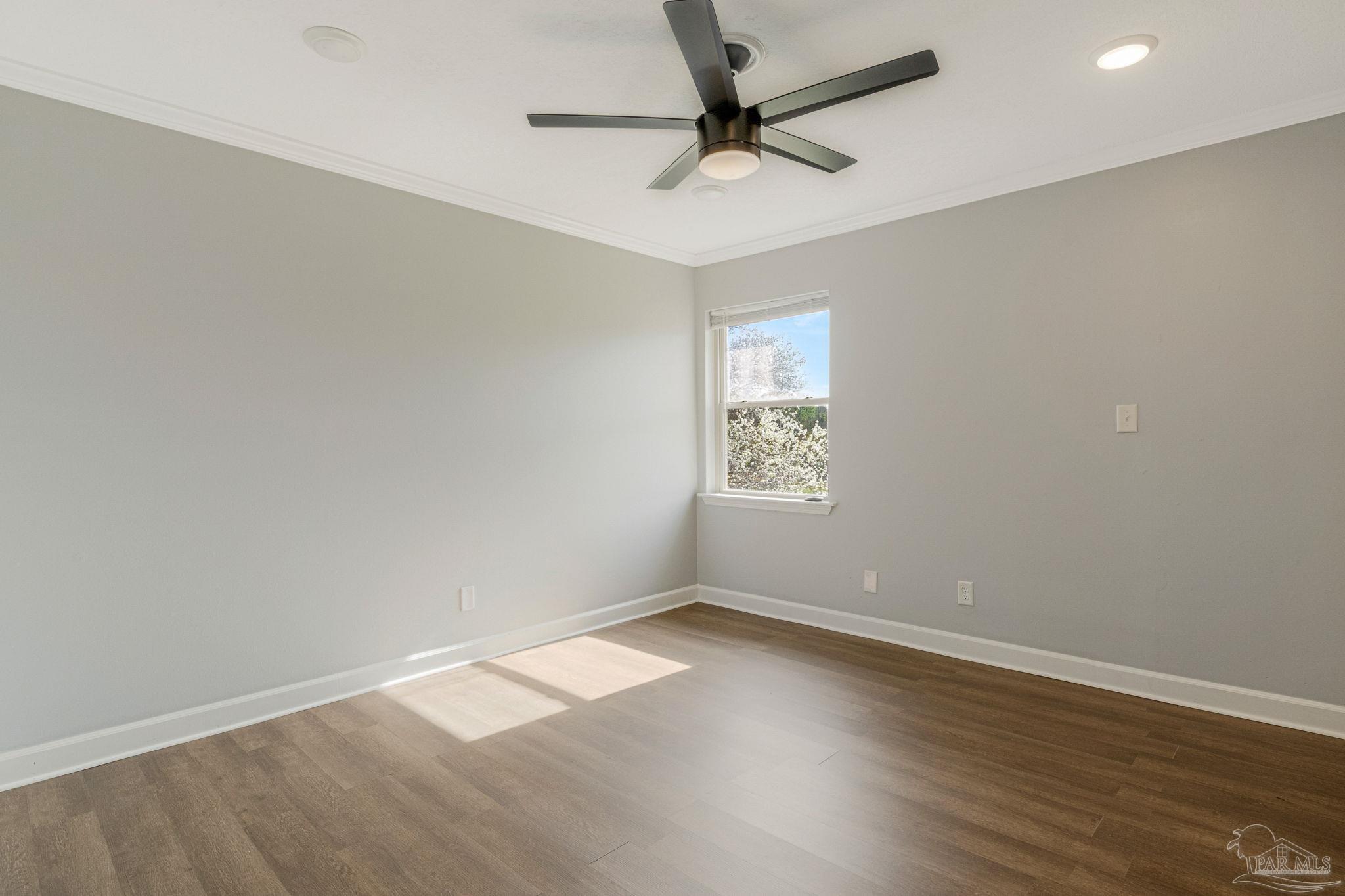 302 Garcon Point Road Milton, FL 32583 - Photo 24 of 51 an empty room with a window and a fan