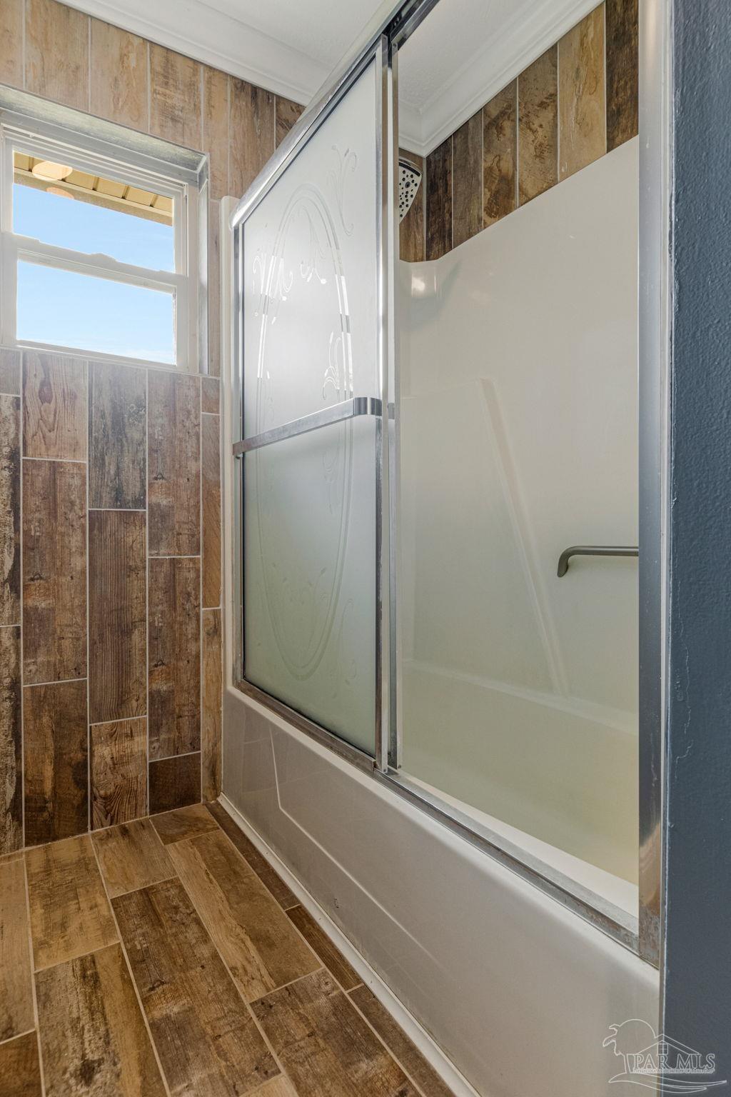 302 Garcon Point Road Milton, FL 32583 - Photo 27 of 51 a bathroom with a shower and a glass door