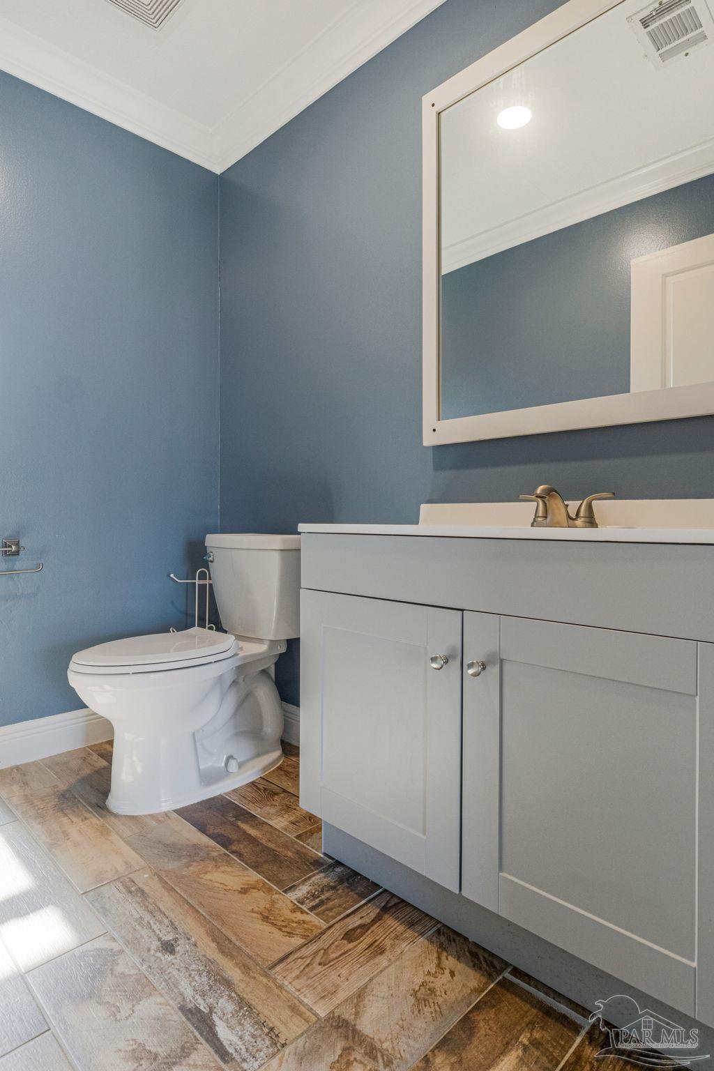 302 Garcon Point Road Milton, FL 32583 - Photo 28 of 51 a bathroom with a toilet sink and mirror