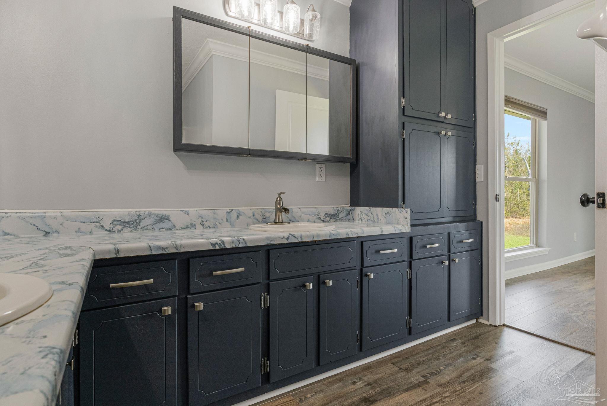 302 Garcon Point Road Milton, FL 32583 - Photo 31 of 51 a bathroom with a granite countertop sink and a mirror