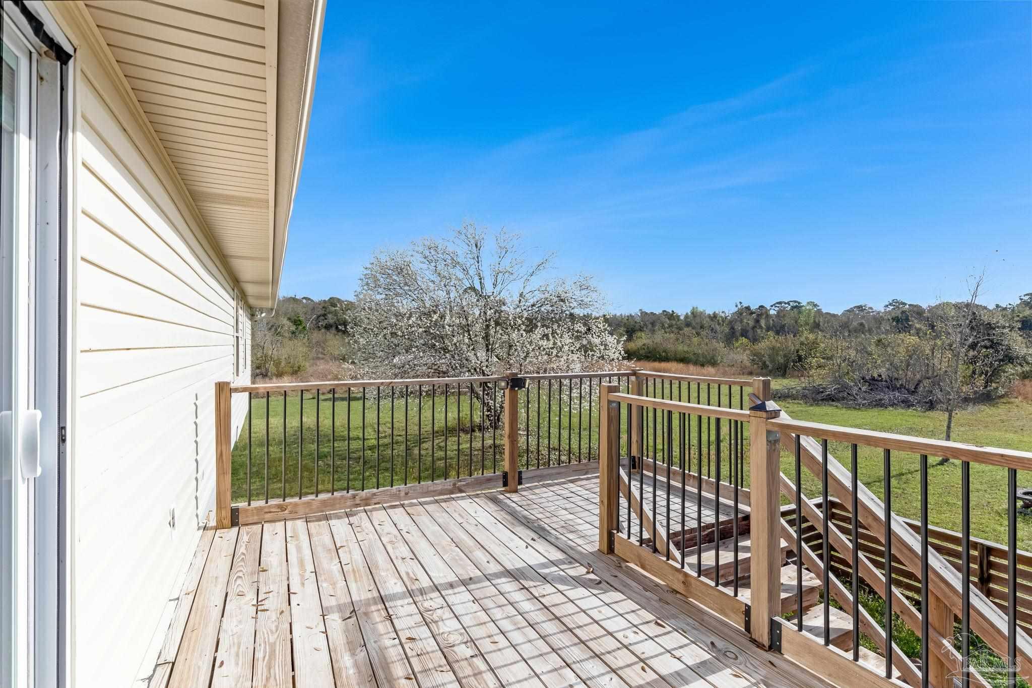 302 Garcon Point Road Milton, FL 32583 - Photo 32 of 51 a view of balcony with wooden floor and fence