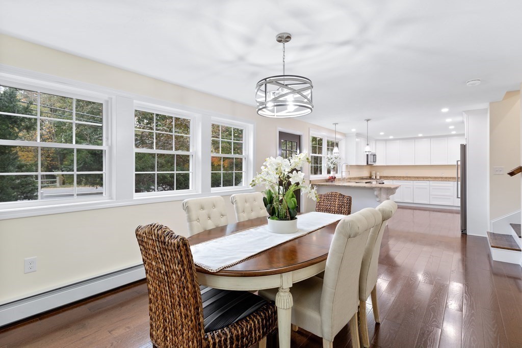 a view of a dining room with furniture wooden floor and chandelier