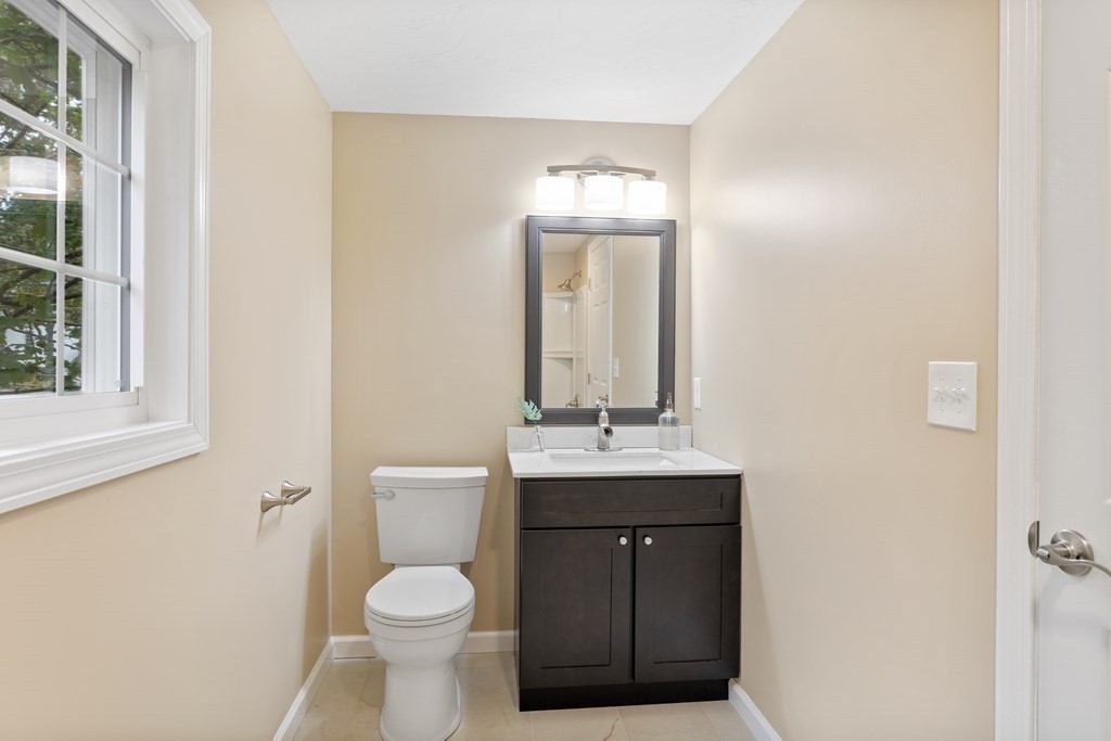 342 Great Road Stow, MA 01775 - Photo 17 of 33 a bathroom with a toilet a sink and mirror