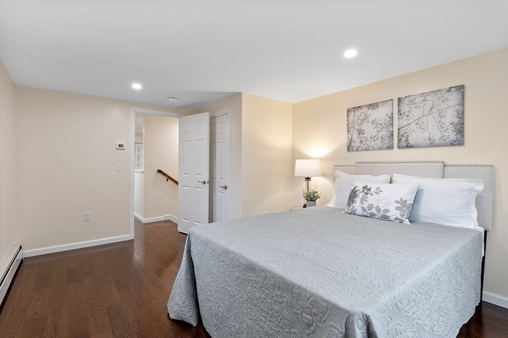 342 Great Road Stow, MA 01775 - Photo 19 of 33 a bedroom with a large bed and a painting on the wall