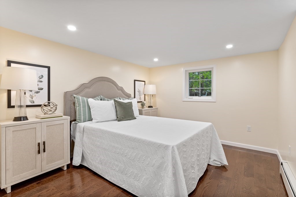 342 Great Road Stow, MA 01775 - Photo 20 of 33 a bedroom with a large bed and wooden floor