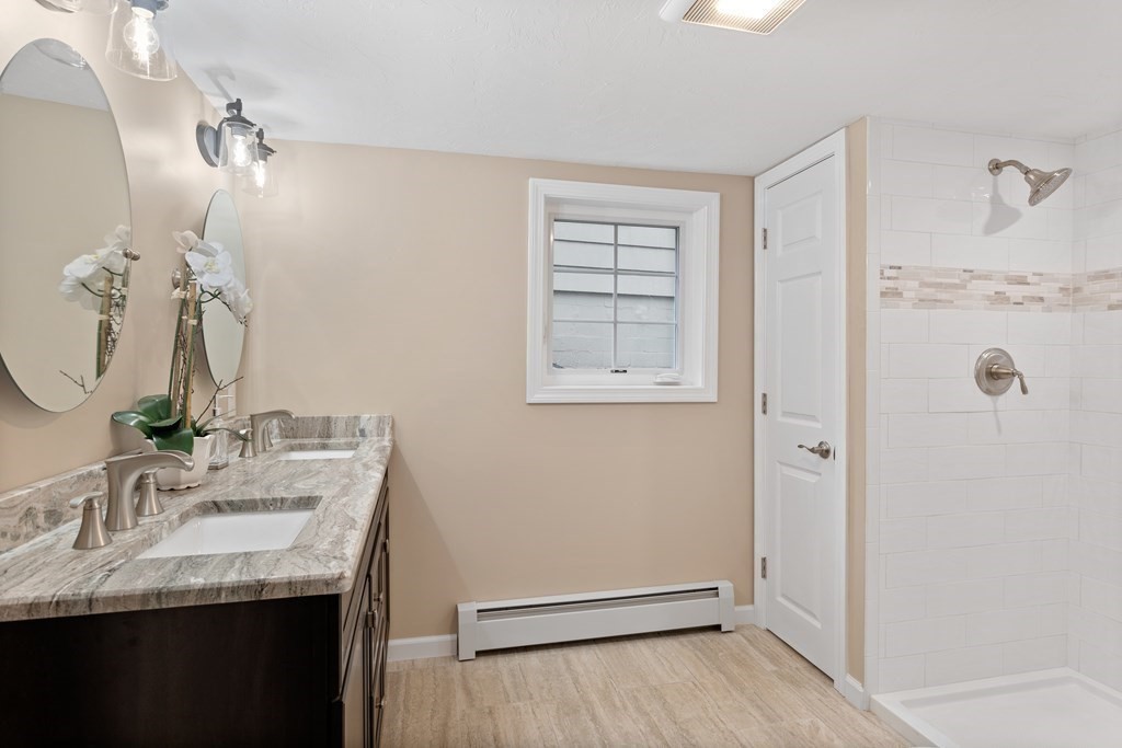 342 Great Road Stow, MA 01775 - Photo 25 of 33 a bathroom with a granite countertop sink and a mirror