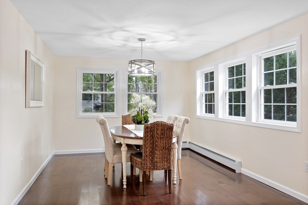 342 Great Road Stow, MA 01775 - Photo 3 of 33 a dining room with furniture large windows and wooden floor
