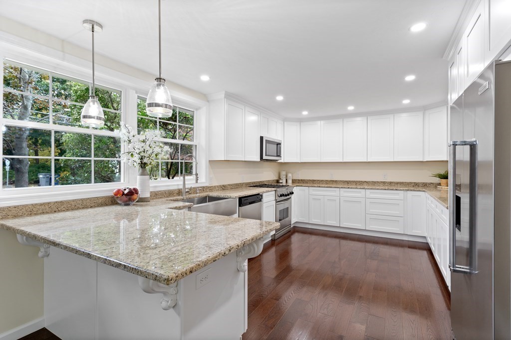 342 Great Road Stow, MA 01775 - Photo 5 of 33 a kitchen with stainless steel appliances granite countertop a stove and kitchen island