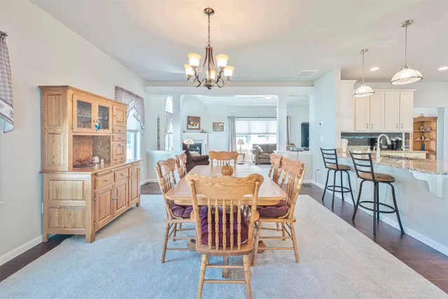 a view of a dining room with furniture and chandelier