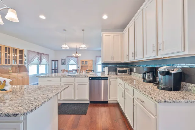 a kitchen with stainless steel appliances granite countertop a sink and cabinets