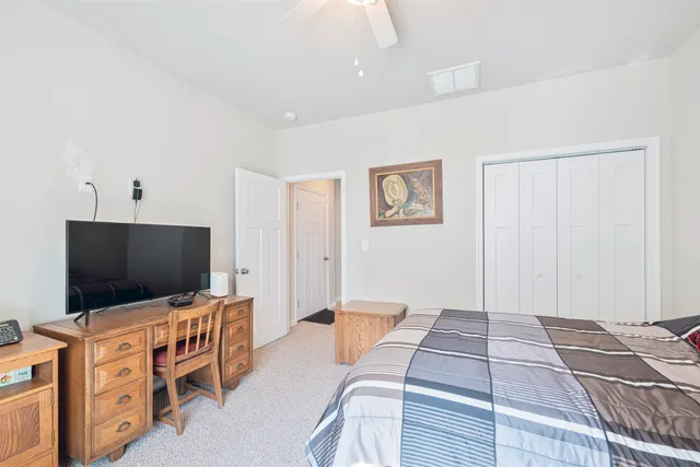 a bedroom with furniture and flat screen tv