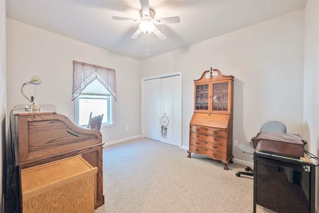 a view of a livingroom with furniture and a window