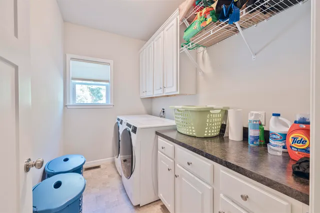 a kitchen with granite countertop lots of clutter and stainless steel appliances