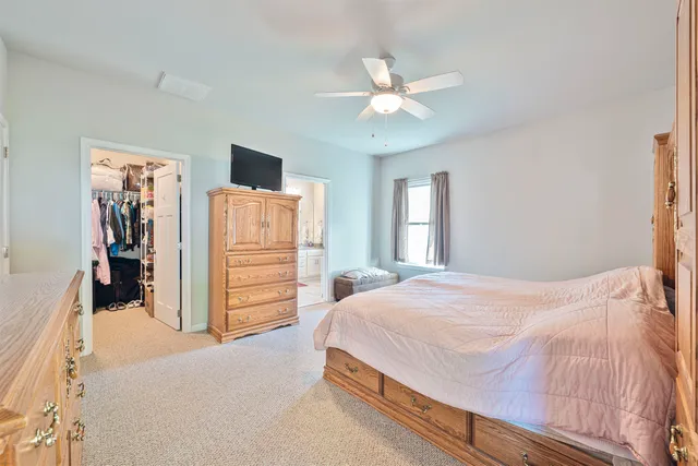 a bedroom with a bed and a flat tv screen