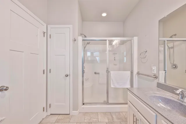 a bathroom with a shower and a sink