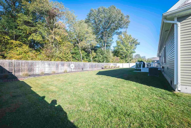 a view of yard with swimming pool and green space