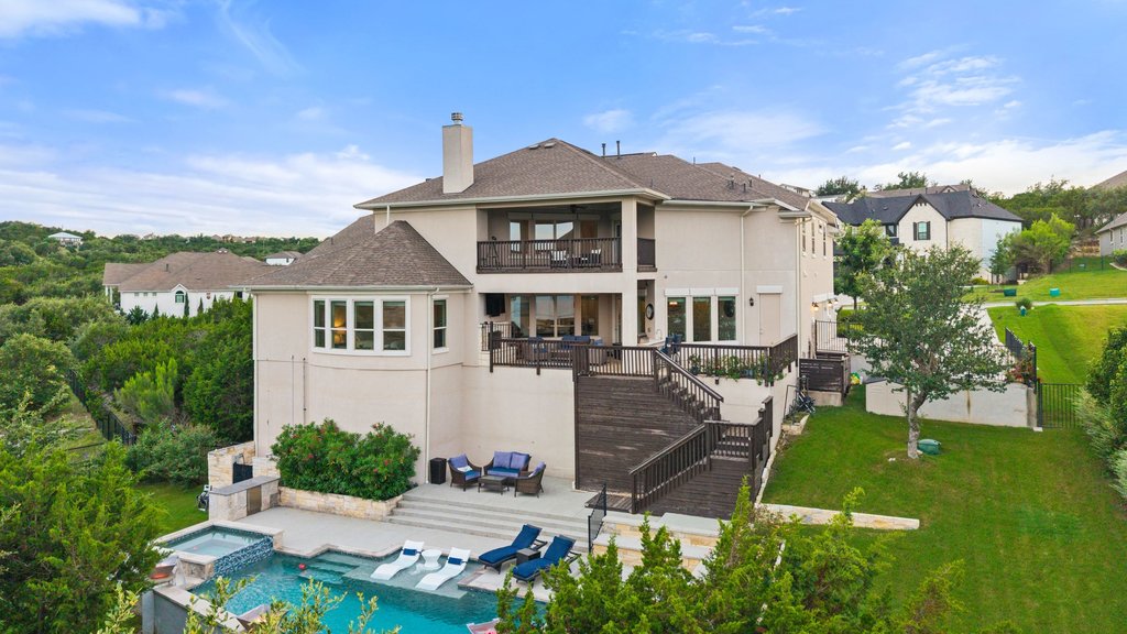 215 Lodestone Lane Austin, TX 78738 - Photo 10 of 40 Elegant home featuring multiple outdoor living spaces and a refreshing pool with an integrated spa.
