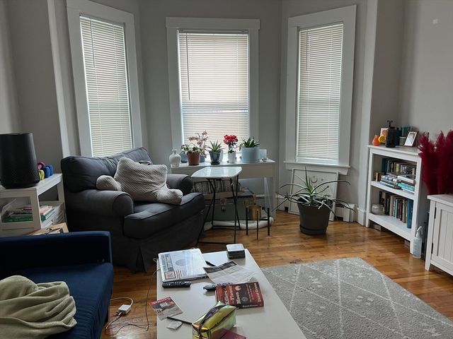 a living room with furniture or couch and a bookshelf