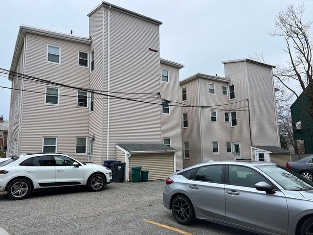 a car parked in front of a white building