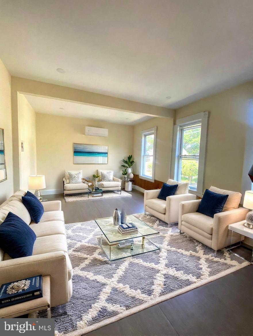 a living room with furniture a rug and a window