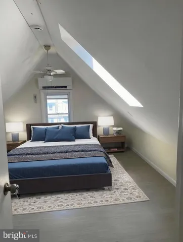 a spacious bedroom with a bed and window