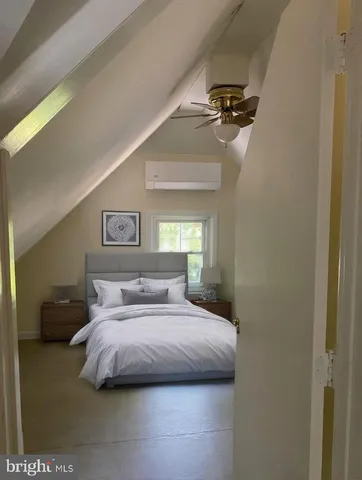 a bedroom with a bed and a painting on the wall