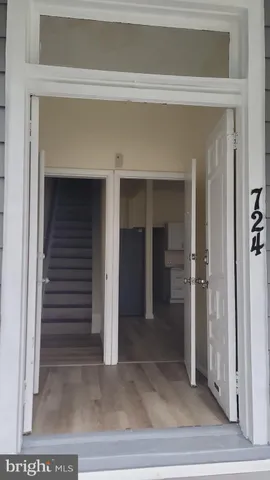 a view of a hallway with wooden shelves