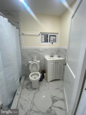 a bathroom with a toilet a sink and shower