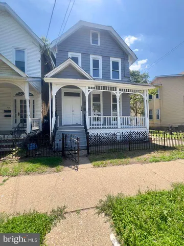 a front view of a house with a yard table and chairs