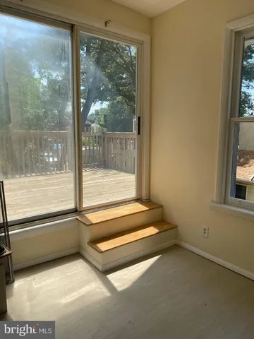 a view of an empty room with a floor to ceiling window and a floor to ceiling window
