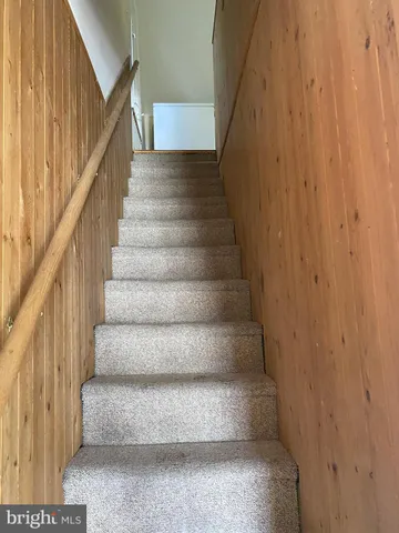 a view of staircase with white walls