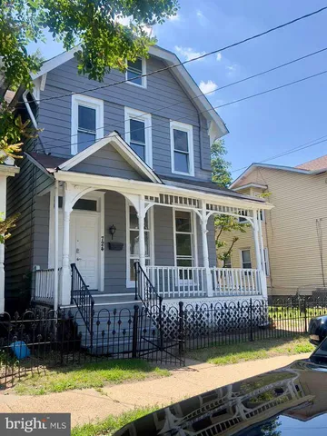 a front view of a house with a yard with wooden fence