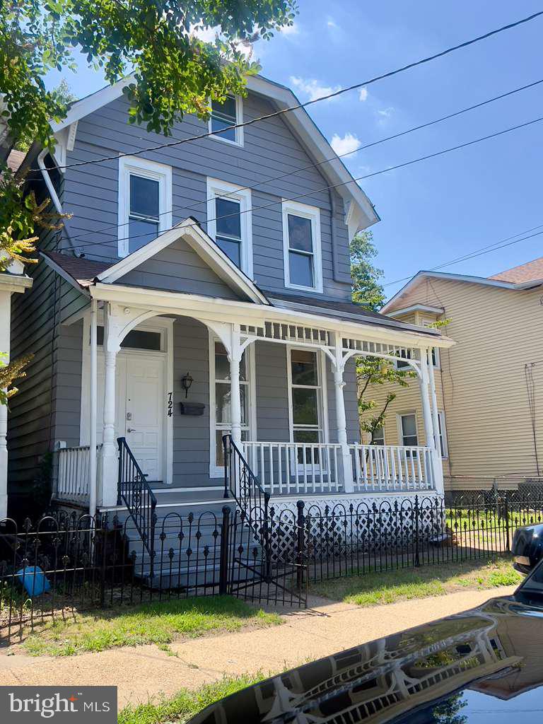 724 Hunter Street Gloucester City, NJ 08030 - Photo 39 of 47 a front view of a house with a yard with wooden fence