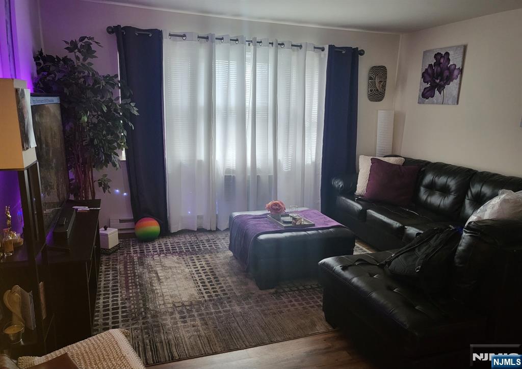 205 Bergen Turnpike, Unit 2A Ridgefield Park, NJ 07660 - Photo 5 of 13 a living room with furniture and a potted plant