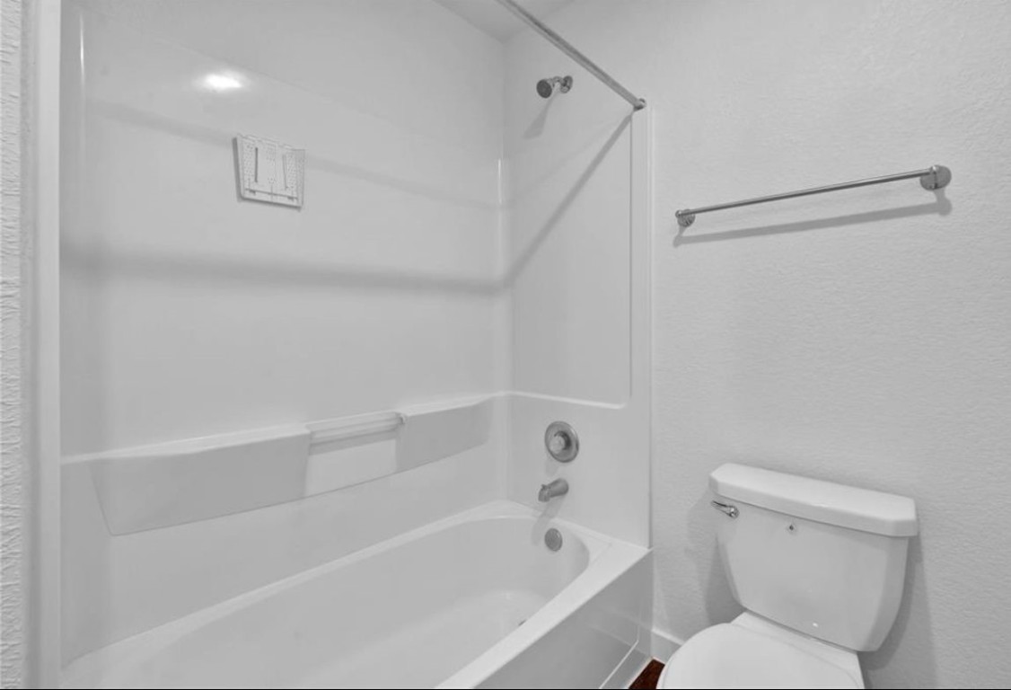 12603 Telge Road, Unit 28C Cypress, TX 77429 - Photo 11 of 25 a bathroom with a toilet and a bathtub